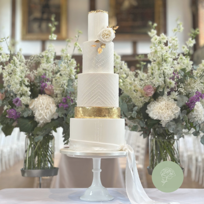Romantic 4 tier wedding cake featuring stencil detail, silk ribbon and sugar flower
